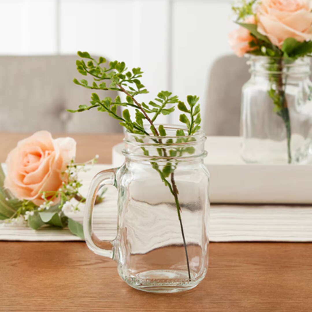 A group of flowers in glass vases
